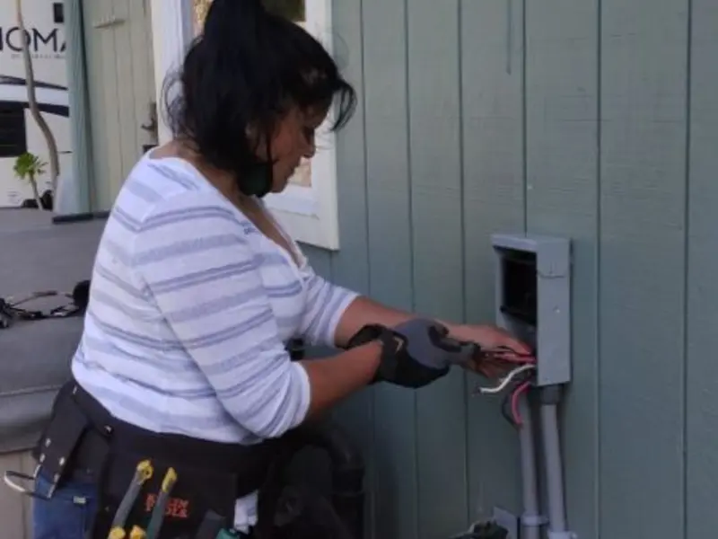 Licensed electrician wiring an exterior subpanel in Chula Vista